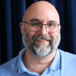 Smiling bald man with glasses