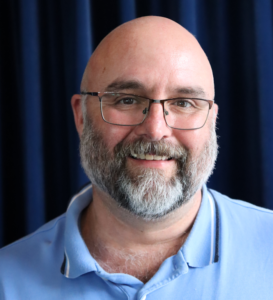 Smiling bald man with glasses
