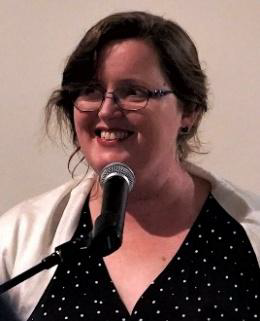Woman speaking into a microphone