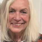 Smiling older woman with long white hair