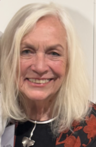 Smiling older woman with long white hair