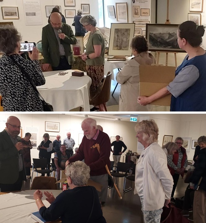 Art exhibition visitors discussing paintings.