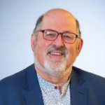 Smiling man in glasses and blazer