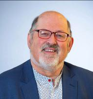 Smiling man in glasses and blazer