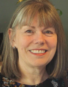 Smiling woman with shoulder-length hair and bangs